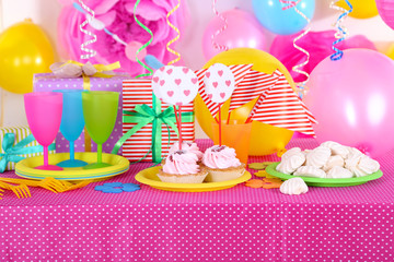 Festive table setting for birthday on celebratory decorations