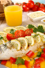 Delicious grilled fish on plate on table close-up