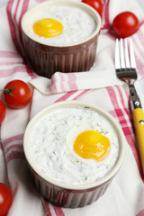 Baked eggs on table close up