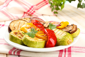 Delicious grilled vegetables on plate on table close-up
