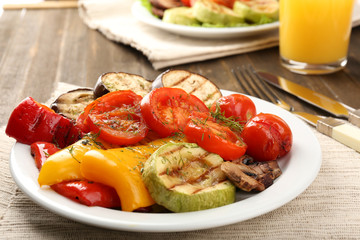 Delicious grilled vegetables on plate on table close-up