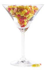 Goblet with pills isolated on white