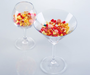 Goblets with pills isolated on white