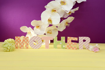 Mother- lettering of handmade paper letters on purple
