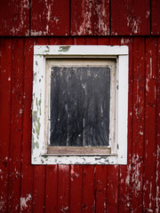 Obraz na płótnie Canvas Weathered old barn and white window frame