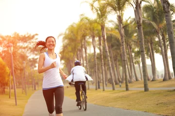 Wallpaper murals Jogging fitness young woman jogging at tropical park