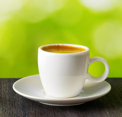 Cup of coffee on nature background