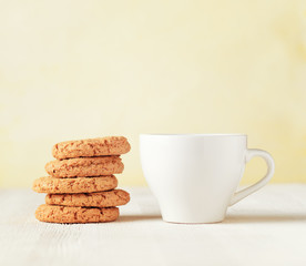 Oatmeal cookies and cup of coffee on wooden table