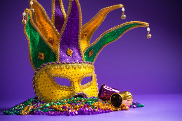 Mardi Gras or Carnivale mask on a purple background