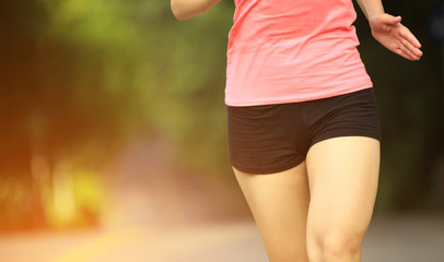 woman runner jogging at forest trail