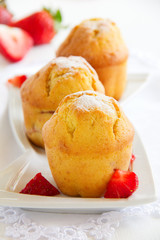 Strawberry muffins on a wooden board.