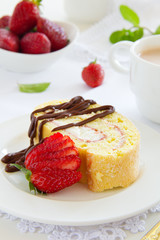 Biscuit roll with strawberry jam, and strawberries.