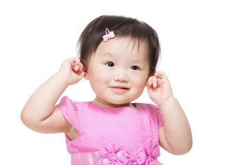 Adorable little girl plugs her ears