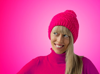 Woman with pink winter hat on pink background