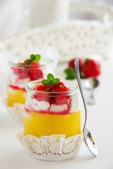 Dessert in a jar with lemon cream, strawberries and granola