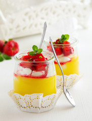 Dessert in a jar with lemon cream, strawberries and granola