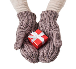 Small present in red box in warm wool gloves