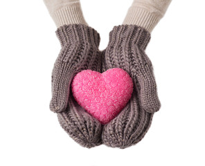 Pink heart in warm wool gloves