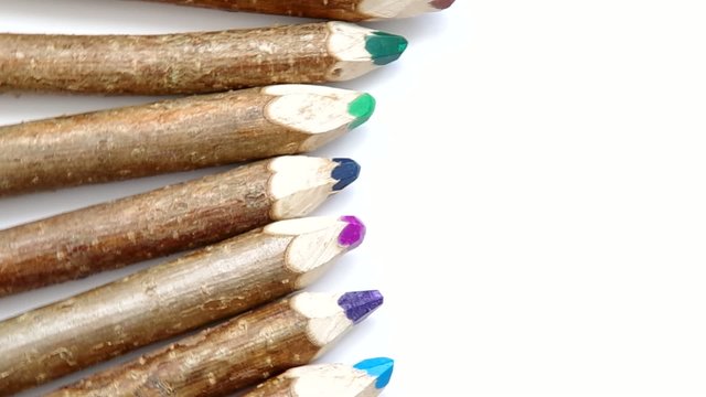 Wooden pencil from branchesare spinning on a white background