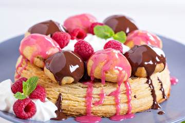 Saint-Honore cake with chocolate and raspberry