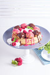 Saint-Honore cake with chocolate and raspberry