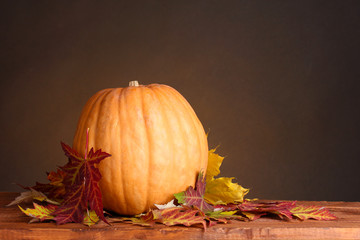 Naklejka na ściany i meble ripe pumpkin and autumn leaves