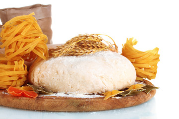 ingredients for homemade pasta on wooden plate isolated on