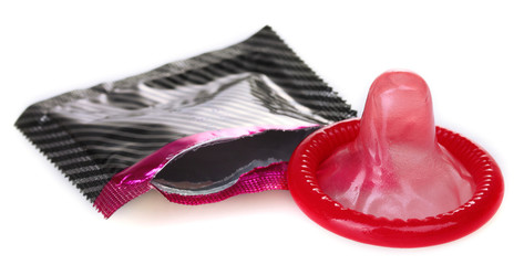 Red condom with  open pack isolated on white - obrazy, fototapety, plakaty