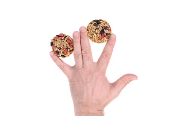Round candied seeds and nuts in hand.