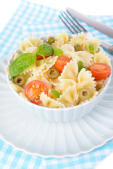Delicious pasta with tomatoes on plate on table close-up