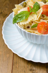 Delicious pasta with tomatoes on plate on table close-up