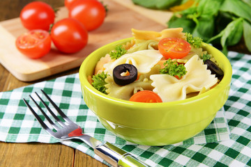 Delicious pasta with tomatoes on plate on table close-up