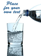 Pour water from bottle into  glass, on light blue background