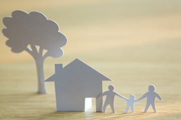 Paper cut of family with house and tree