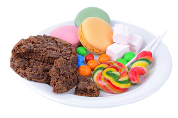 Different sweets on plate isolated on white