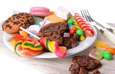 Different sweets on plate on table close-up