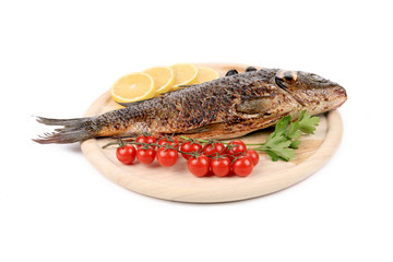 Fried fish on a wooden plate