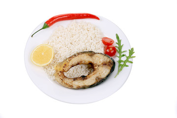 Piece of fried fish with rice and chili pepper
