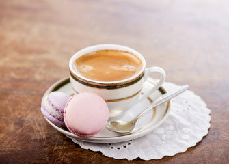 Coffee and French macaroons on a wooden background