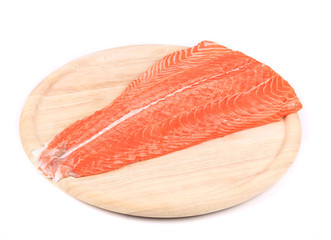 Salmon fillet on wooden platter.