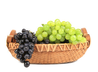 Black and green grapes in basket.
