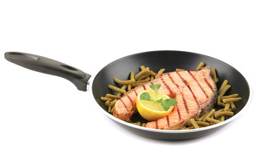 Frying pan with salmon steak.