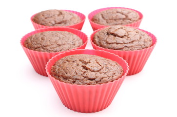 Fresh baked chocolate muffin in red silicone cups
