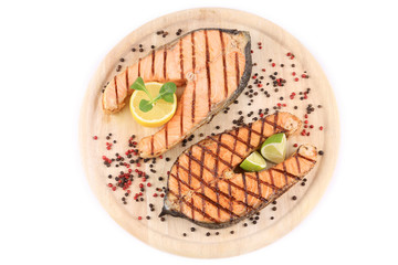 Two salmon steaks on platter.