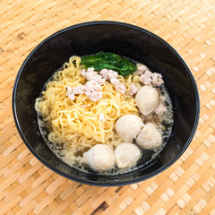Eating instant noodle with minced pork and pork ball