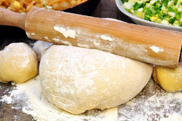 dough, rolling pin and a filling for pies