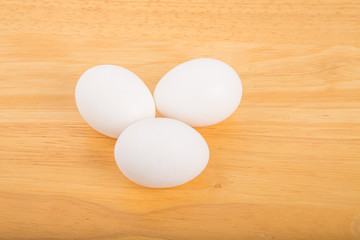 Three Eggs on Wood Table