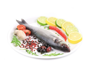 Seabass on plate with citrus and pepper.