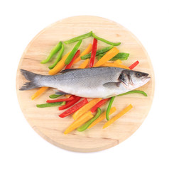 Fresh seabass fish on colorful pepper.