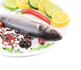 Seabass on plate with citrus and pepper.